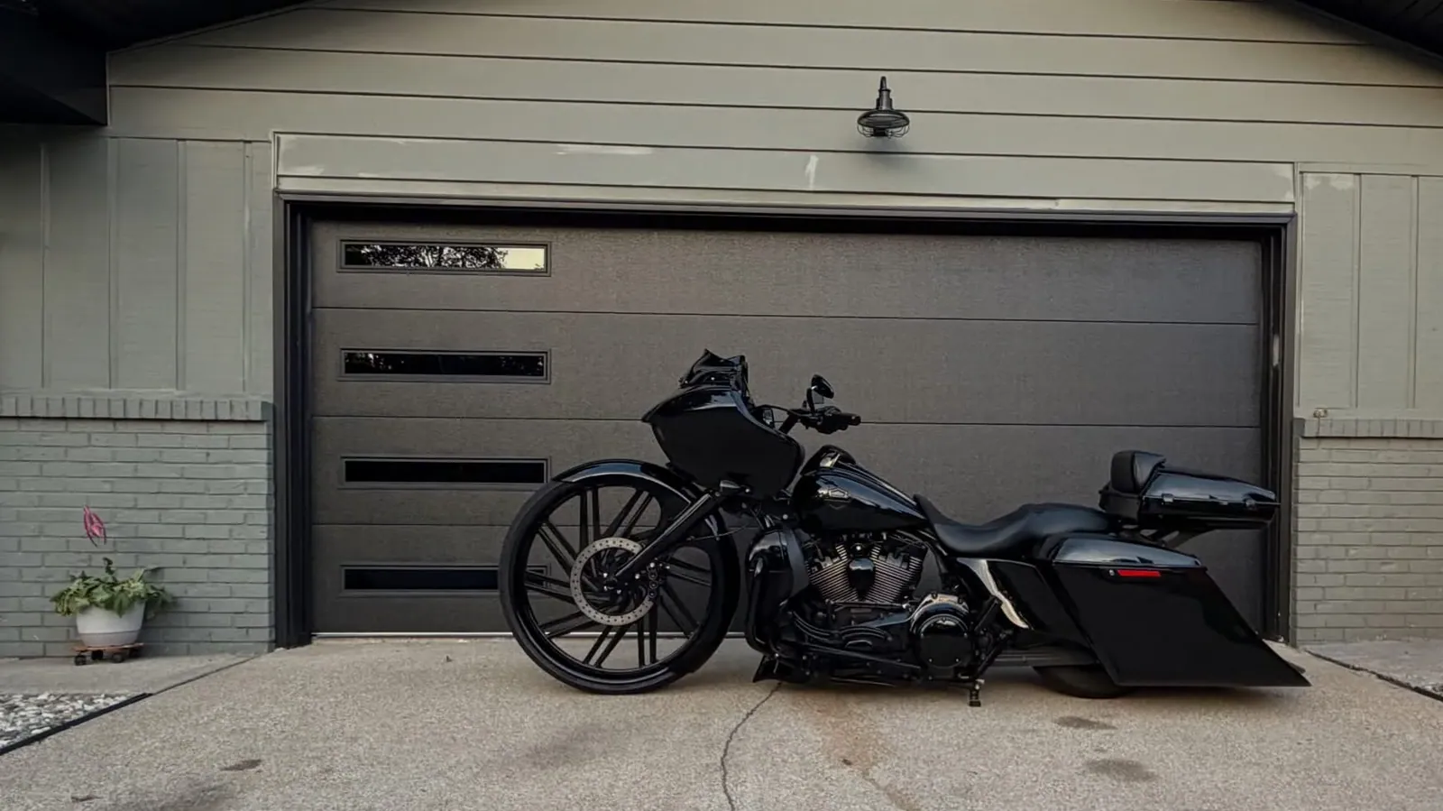 Black flush-panel garage door with vertical window lites, installed by DNA Garage Doors