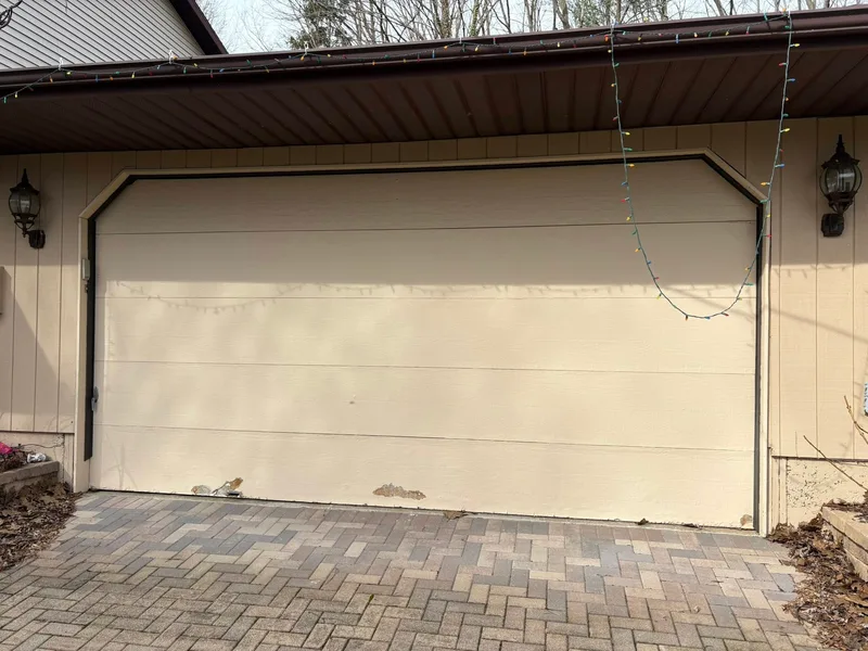 Before — worn garage door needing repair
